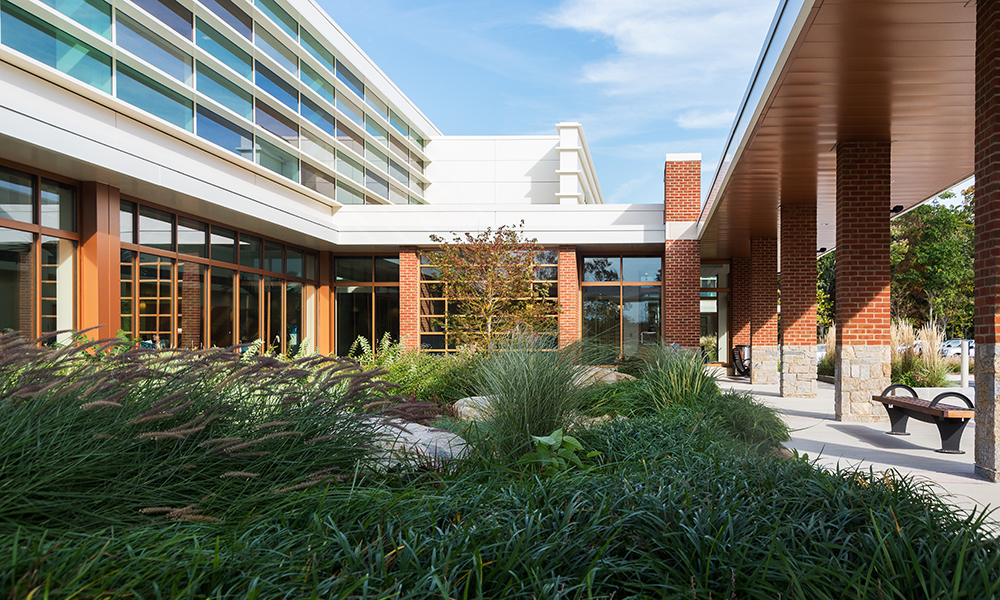 <p>Sustainable elements include: 12’ deep horizontal ribs at south and west windows, Tinted / fritted glass expanses, native plantings, and a robust storm-water management system. The high performance exterior envelope and HVAC systems were designed to meet the “ASHRAE Advanced Energy Design Guide for Small Healthcare Facilities” standards.</p>
