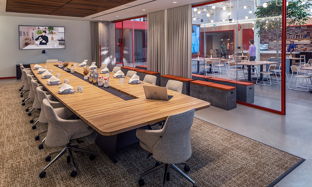 <p>The ebullience of the café bar and lounge beams through double pane glass walls of adjacent meeting rooms.</p>
