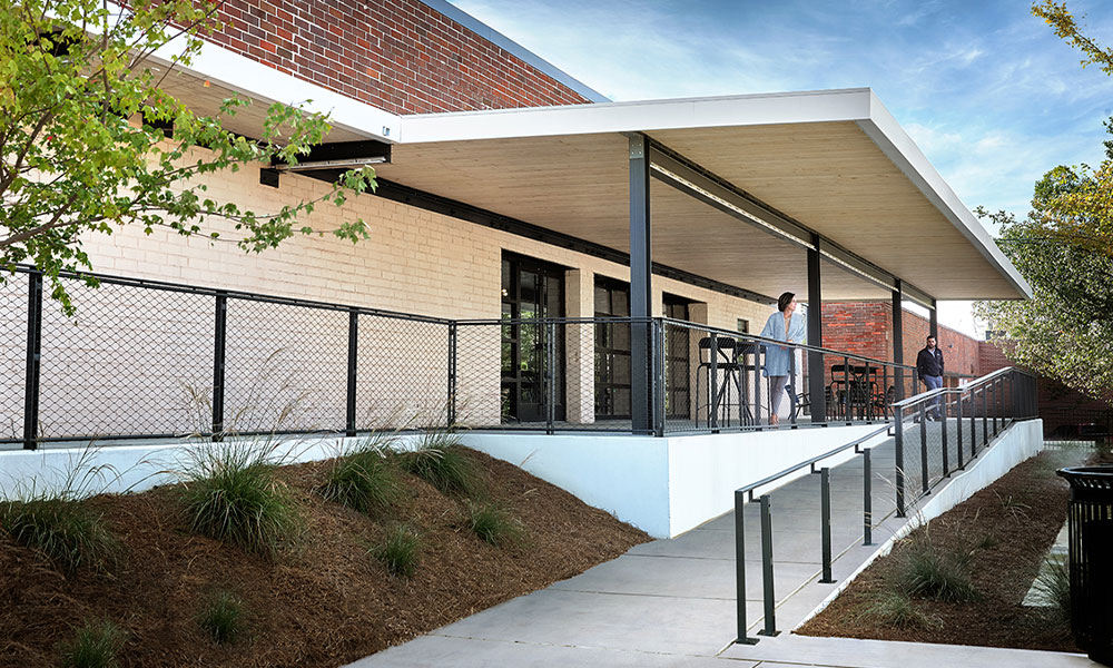 <p>A large, gentle ramp to a shaded patio makes riding a bike to work easy while going beyond mere accessibility compliance to provide an inclusive and approachable workplace for everyone.</p>
